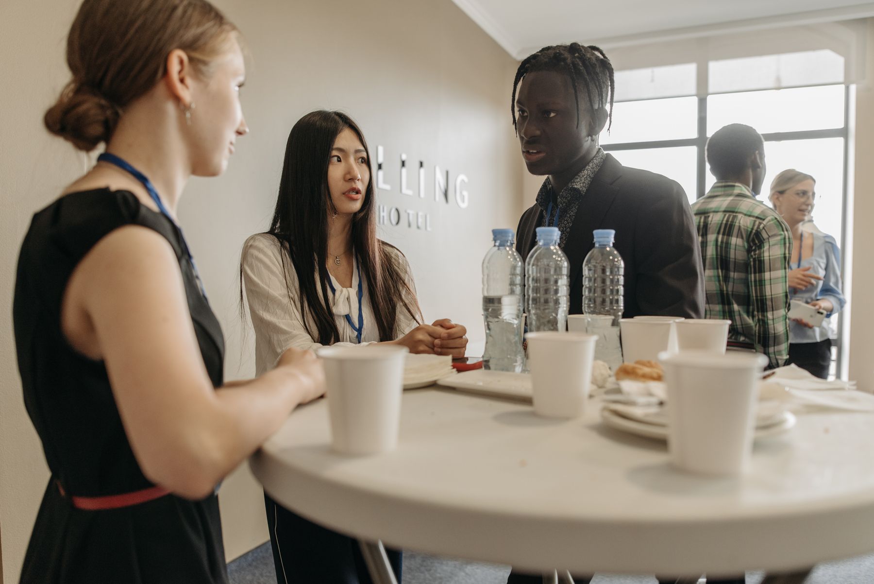 Black professionals exchanging ideas around a table indoors